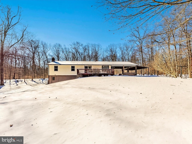 snow covered property with a wooden deck