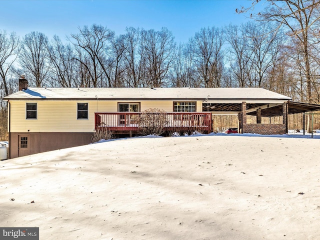 snow covered house with a deck