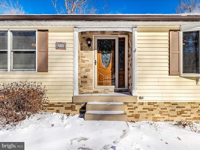 view of snow covered property entrance