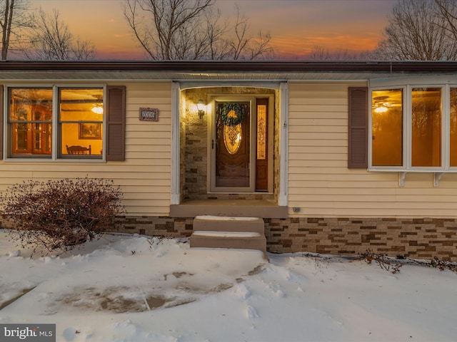 view of snow covered property entrance