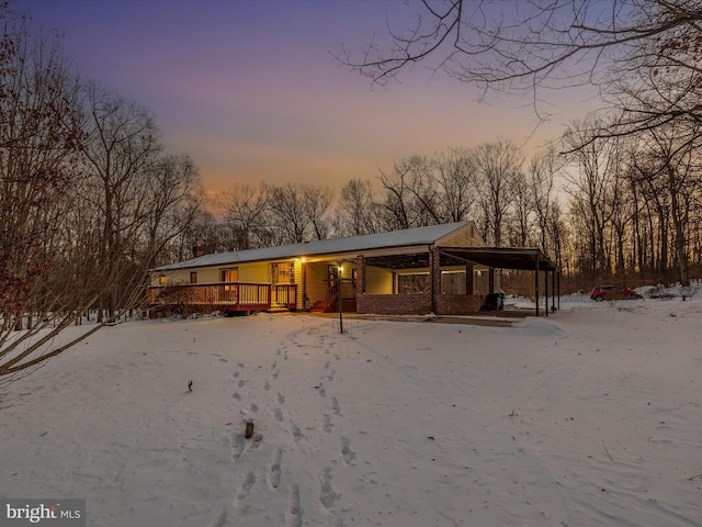 view of front facade featuring a carport and a deck