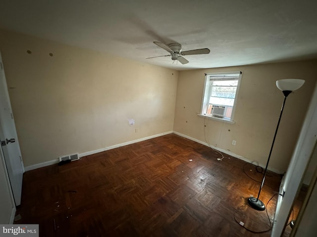 unfurnished room with dark parquet floors, ceiling fan, and cooling unit