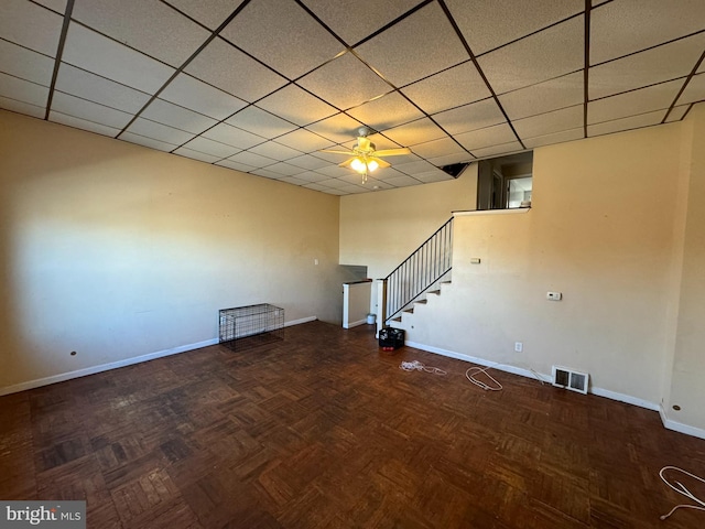 interior space with dark parquet flooring and ceiling fan