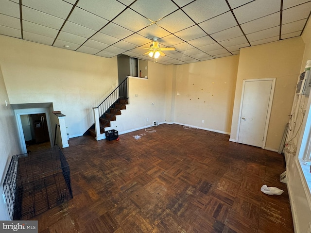 basement with dark parquet floors and ceiling fan