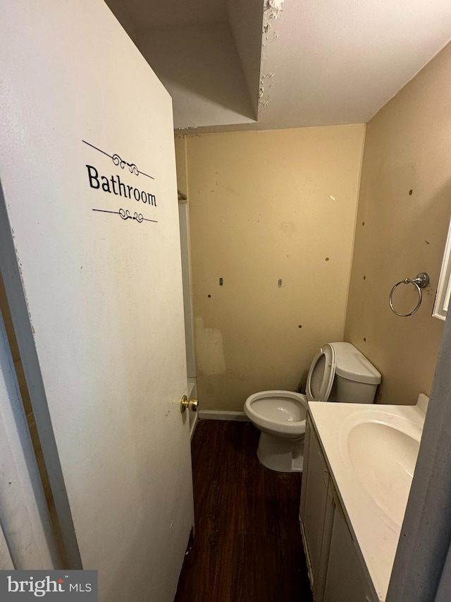 bathroom featuring vanity, wood-type flooring, and toilet