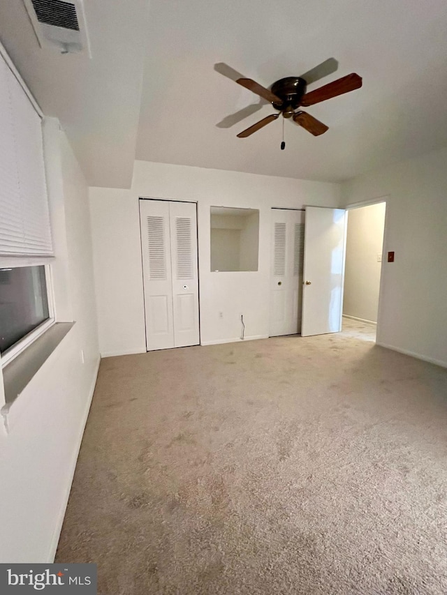 unfurnished bedroom featuring carpet flooring and ceiling fan