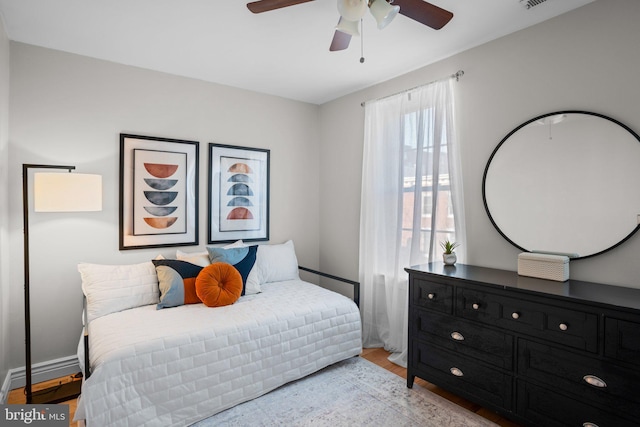 bedroom with ceiling fan and light hardwood / wood-style flooring