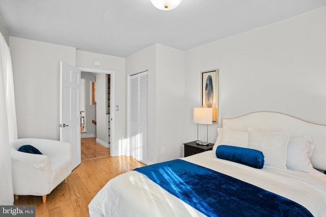 bedroom with a closet and hardwood / wood-style floors