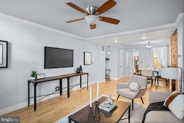 living room with ceiling fan, light hardwood / wood-style flooring, and crown molding