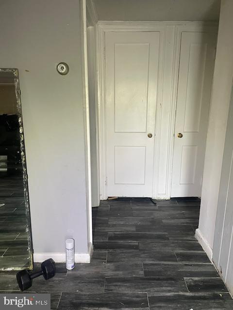 hallway with dark hardwood / wood-style floors