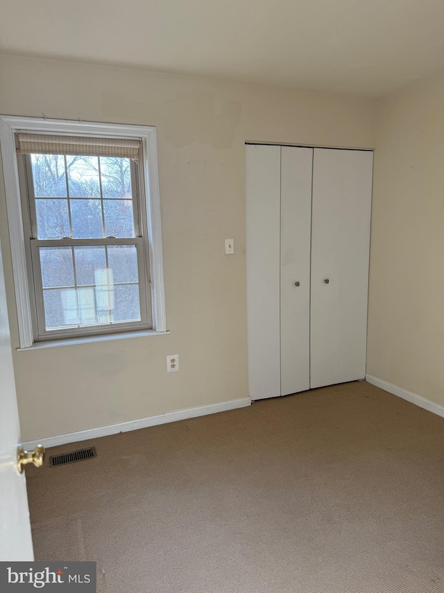 unfurnished bedroom featuring a closet and carpet