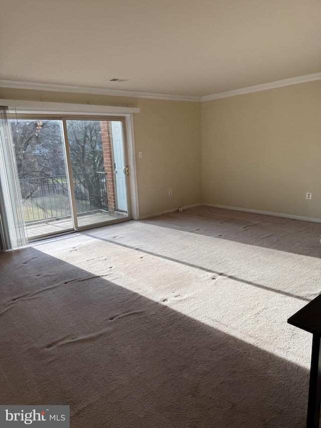 unfurnished room featuring carpet flooring and crown molding