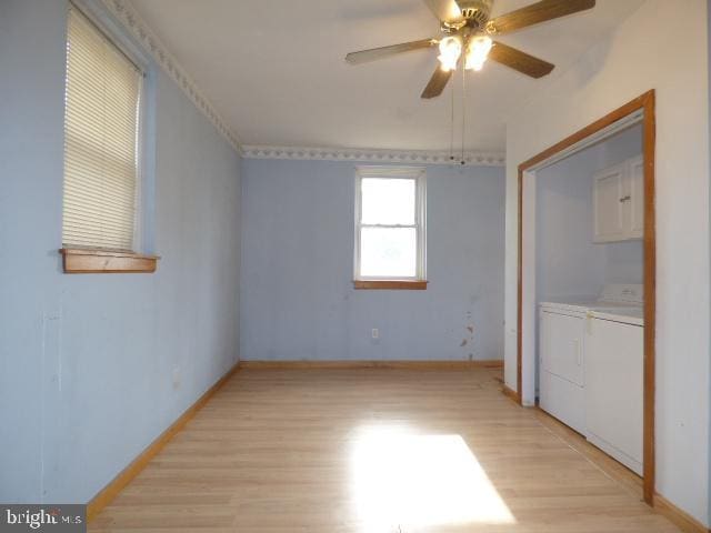 unfurnished bedroom featuring ceiling fan, washer and clothes dryer, and light wood-type flooring