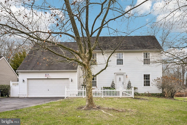 view of front of property featuring a garage and a front lawn