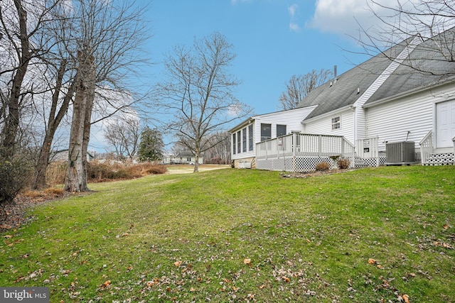 view of yard featuring a deck and central air condition unit