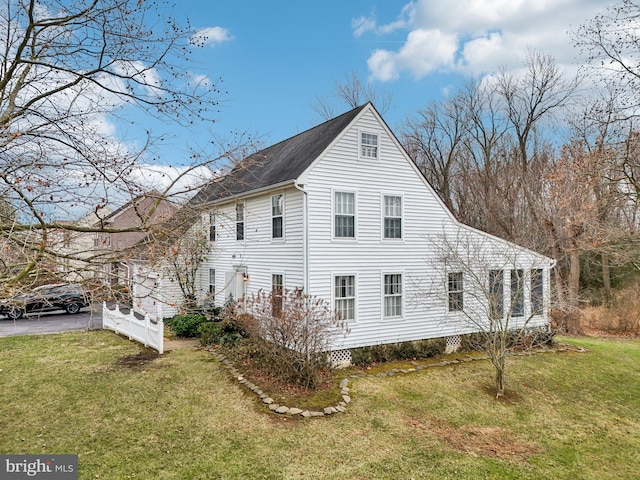 view of side of home featuring a lawn