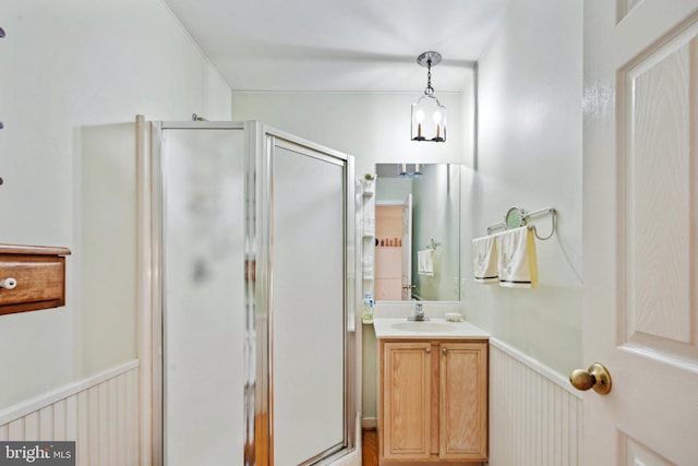 bathroom featuring vanity and a shower with shower door