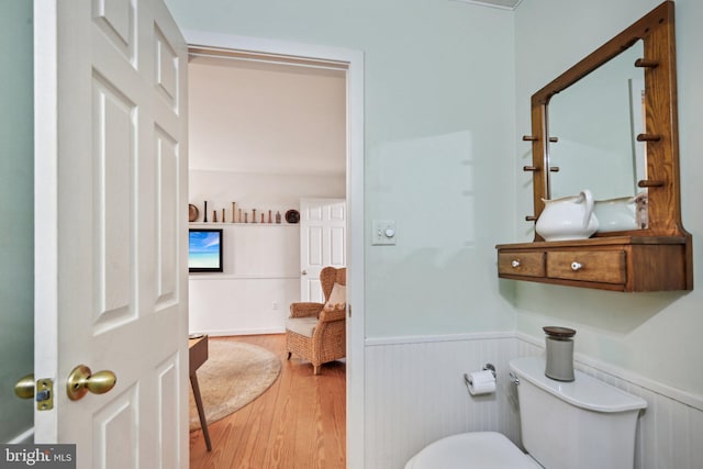 bathroom featuring hardwood / wood-style flooring and toilet