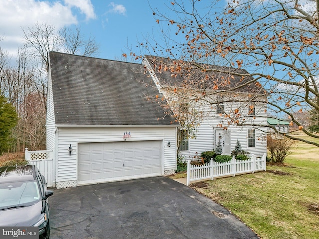 view of front of home featuring a garage and a front lawn