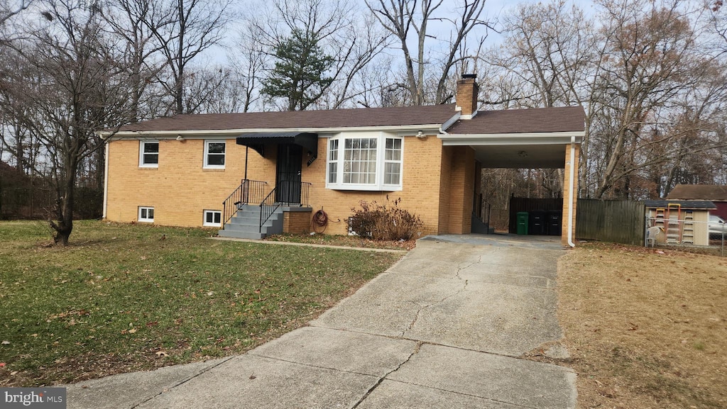 view of front of house with a carport and a front lawn