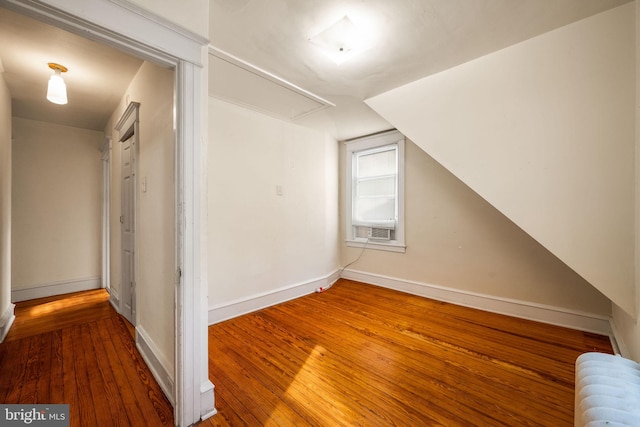 bonus room featuring lofted ceiling, cooling unit, wood-type flooring, and radiator heating unit