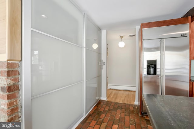 kitchen with built in fridge and a baseboard radiator