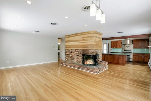 unfurnished living room with a fireplace and light hardwood / wood-style flooring