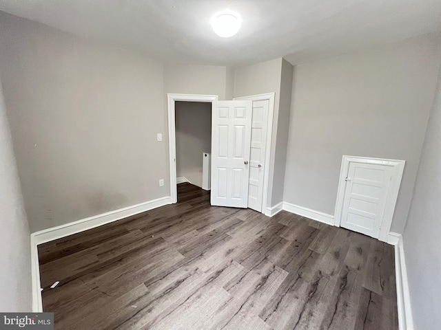 unfurnished bedroom with hardwood / wood-style flooring