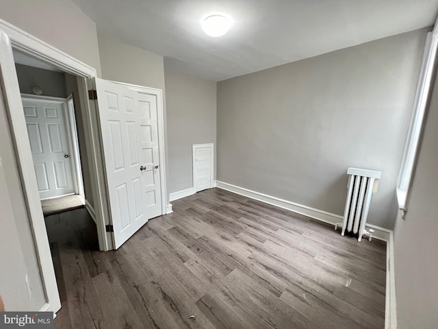 interior space featuring radiator and hardwood / wood-style flooring