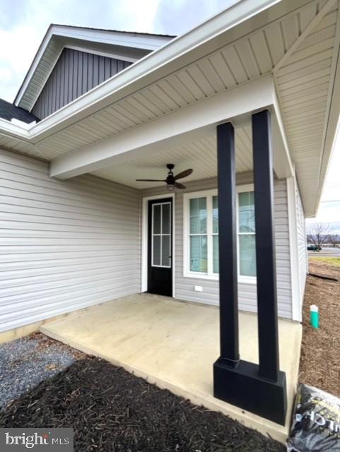 doorway to property featuring ceiling fan