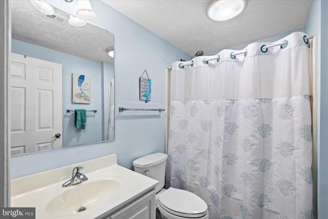 bathroom featuring vanity, a shower with curtain, a textured ceiling, and toilet