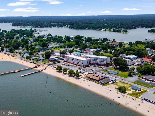 bird's eye view with a water view and a beach view