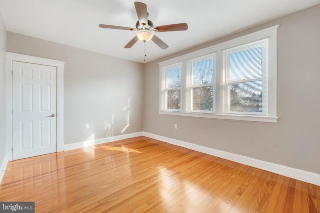 empty room featuring ceiling fan and hardwood / wood-style flooring