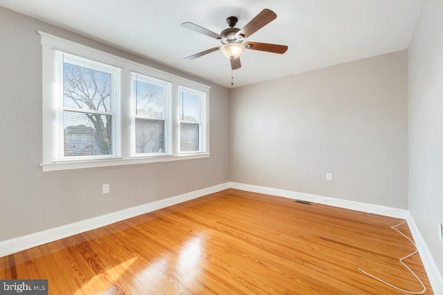 unfurnished room with ceiling fan and wood-type flooring