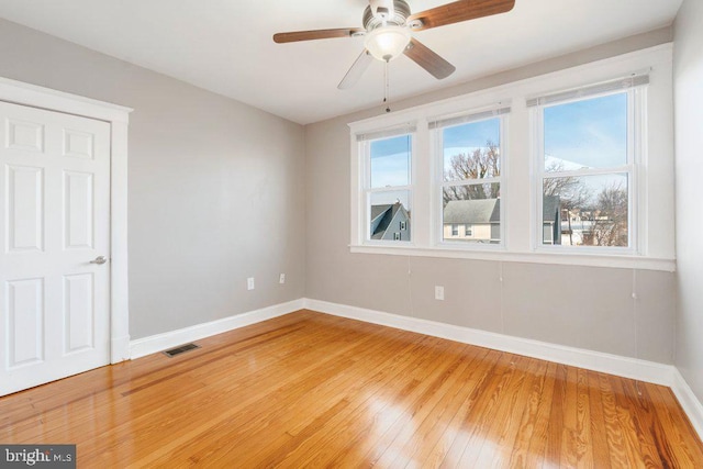 empty room featuring ceiling fan and hardwood / wood-style flooring