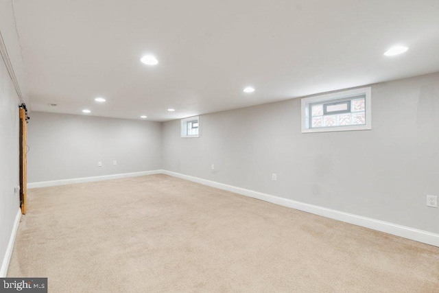 basement with light carpet and a healthy amount of sunlight