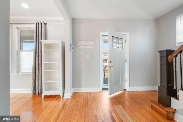 foyer with light hardwood / wood-style floors and a wealth of natural light