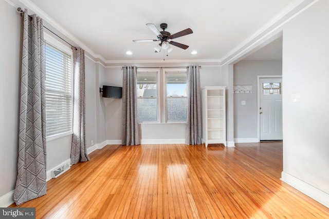 unfurnished room with light hardwood / wood-style flooring, ceiling fan, and ornamental molding