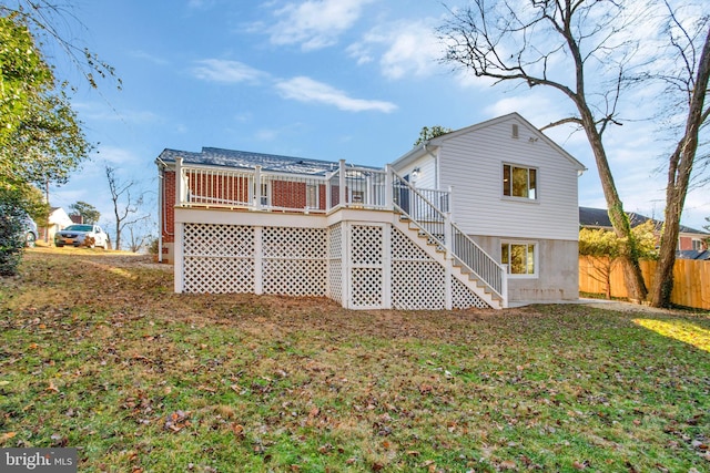 back of house with a yard and a deck