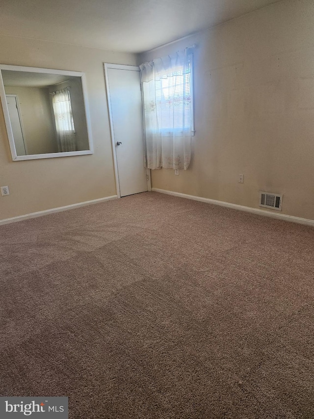 carpeted empty room with plenty of natural light