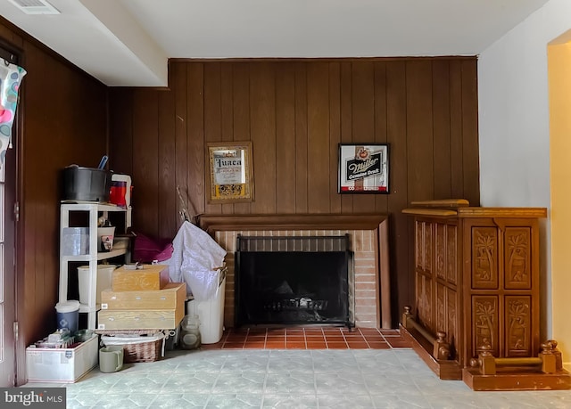 living room with wood walls and a fireplace