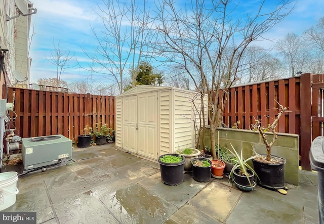 view of patio with central AC and a storage unit