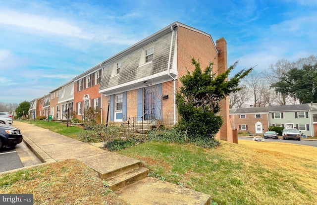 view of side of home with a yard