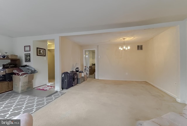 carpeted living room featuring a notable chandelier