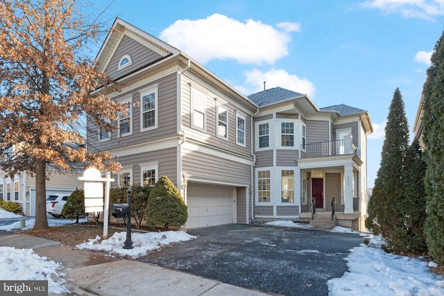 view of front of home featuring a garage and a balcony