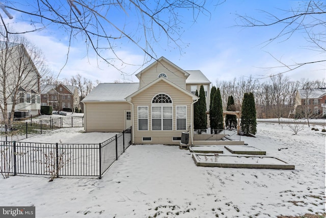 view of snow covered back of property