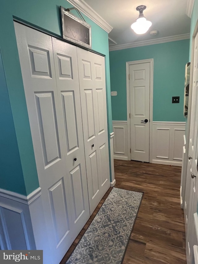 hall with ornamental molding and dark hardwood / wood-style flooring