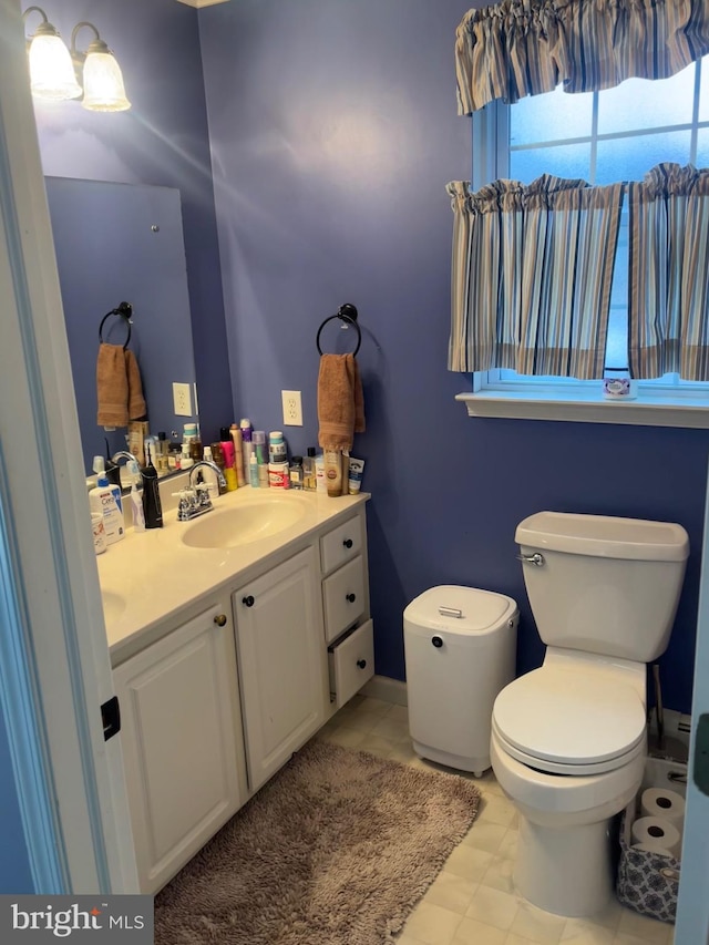 bathroom featuring vanity and toilet