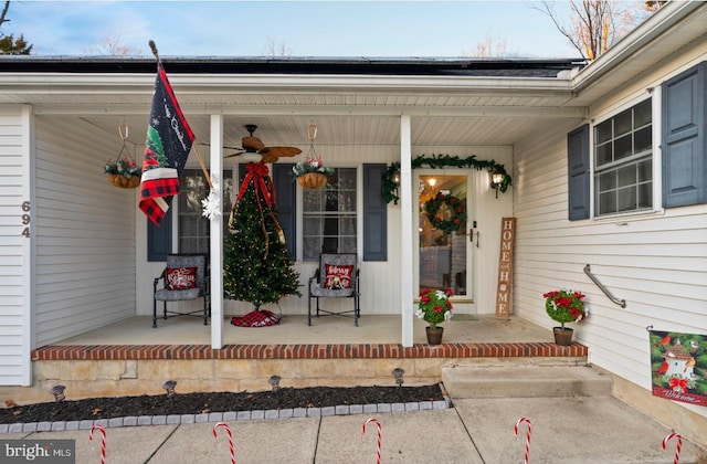 doorway to property with ceiling fan and a porch