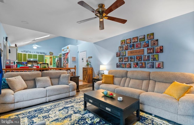 living room featuring hardwood / wood-style flooring, vaulted ceiling, and ceiling fan